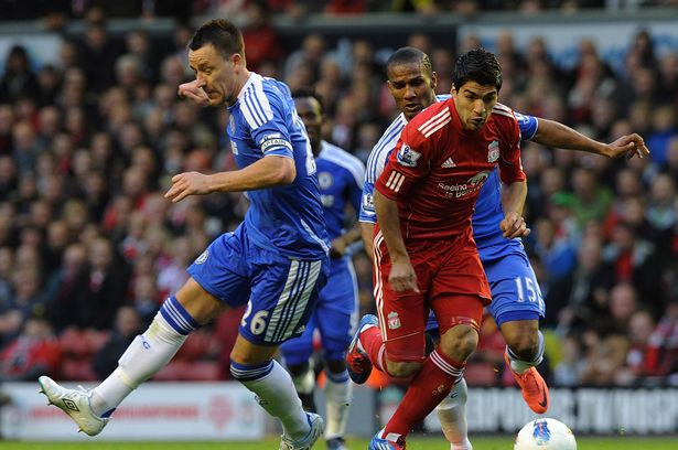 Luis Suarez of Liverpool and John Terry of Chelsea compete